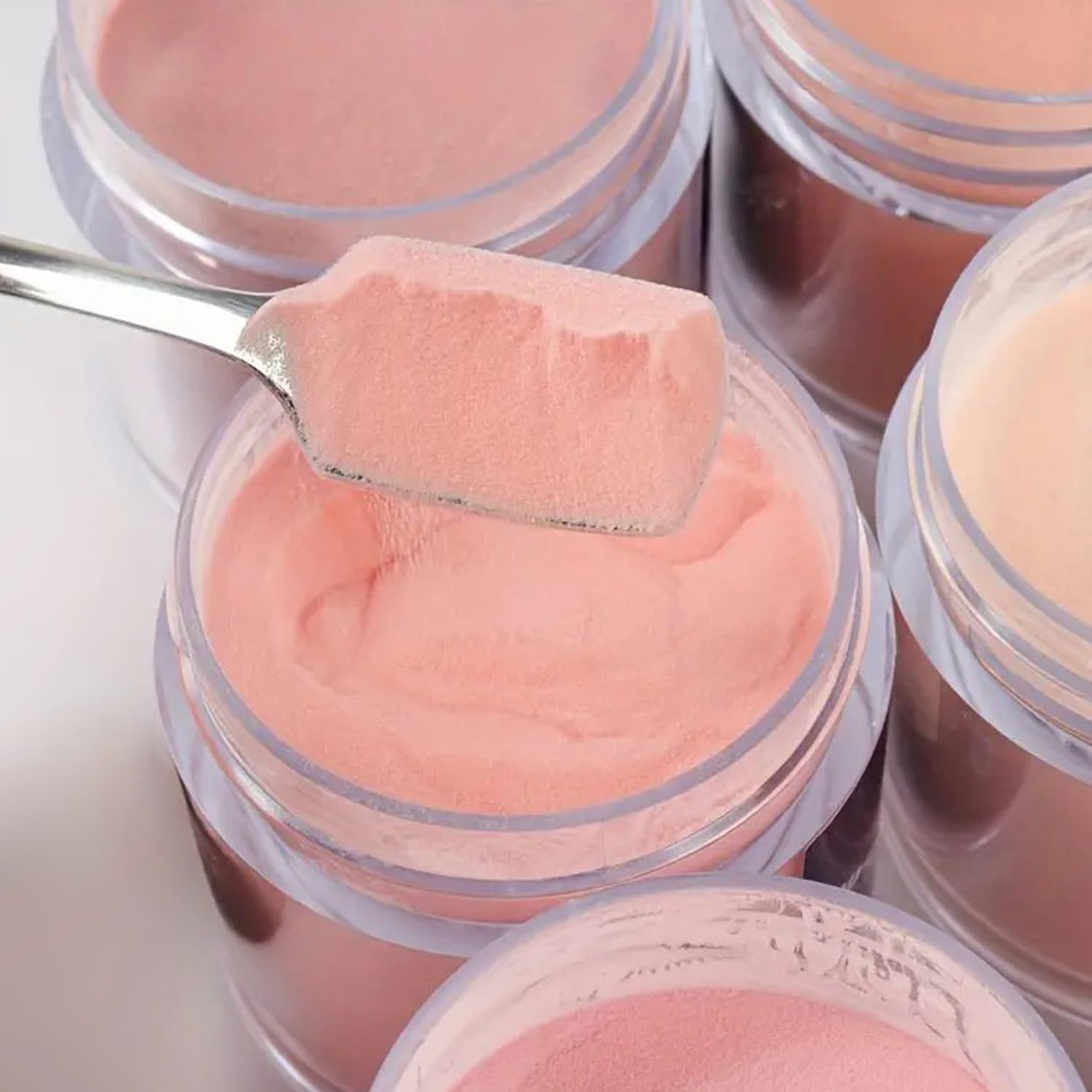Collection of nude acrylic powders for DIY manicure
