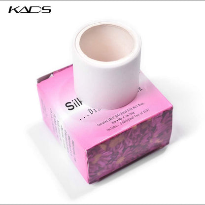 Self adhesive silk nail wrap roll pulling out from the top slit of the KADS box.