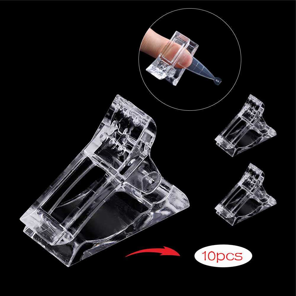 Close up of clear plastic nail builder clamps for manicure