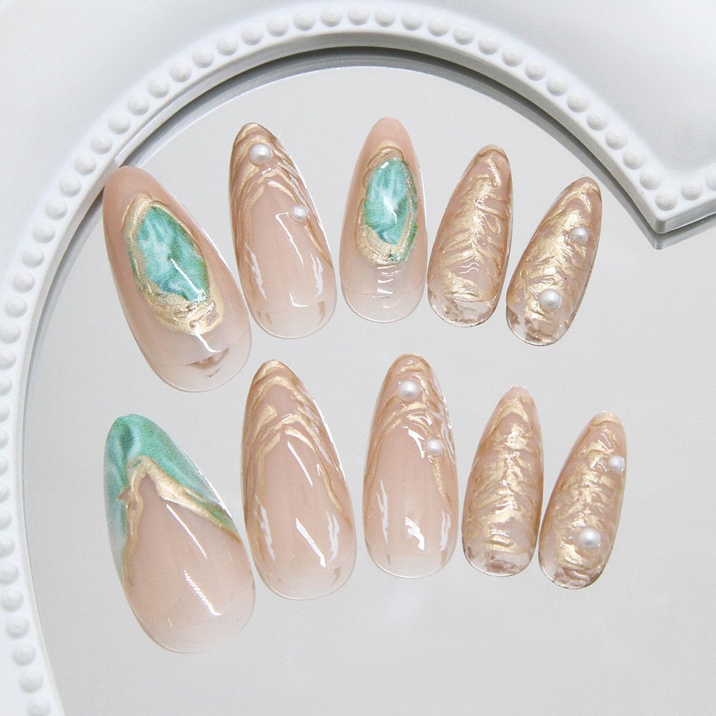 Close up of ASABITE green and gold marble nail art design
