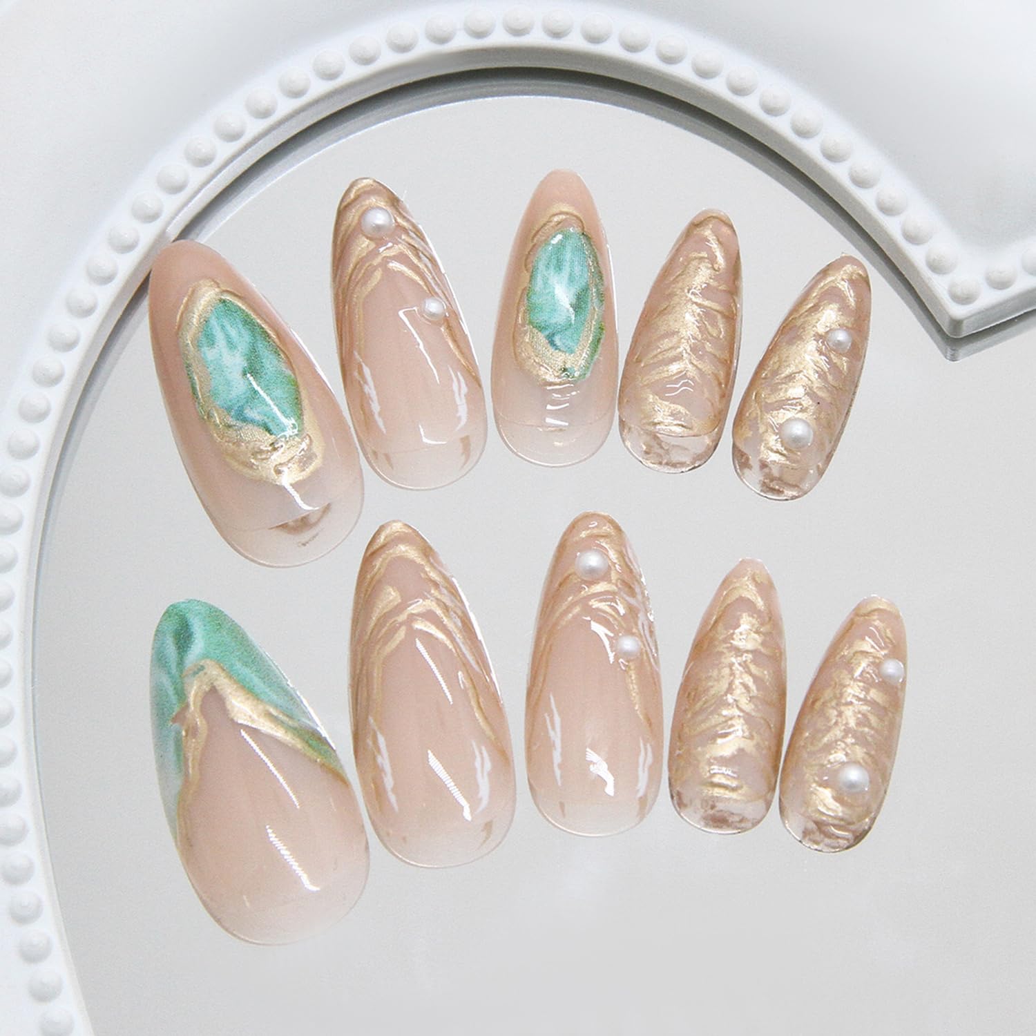 Close up of ASABITE green and gold marble nail art design