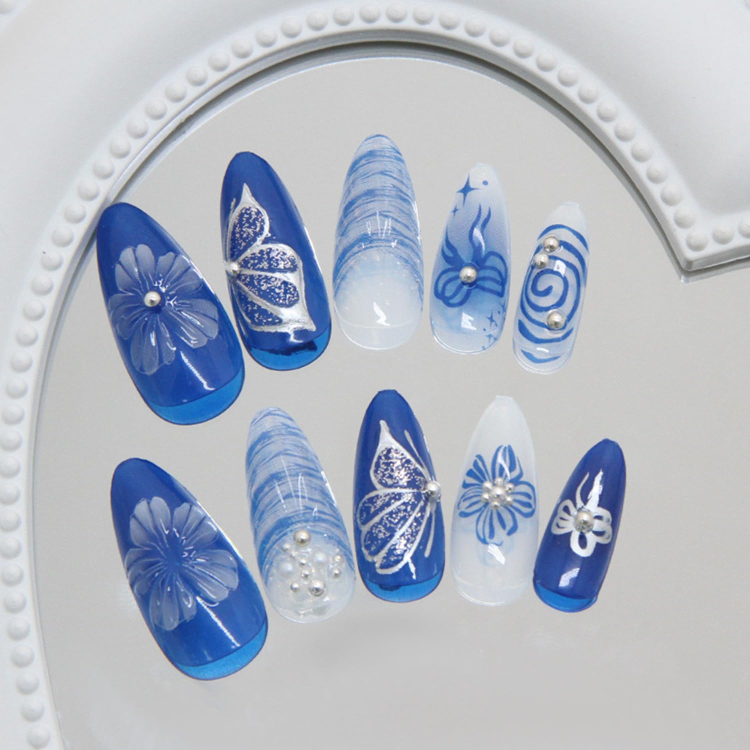 Close up of 3D pearl bow accent on blue gradient press on nails