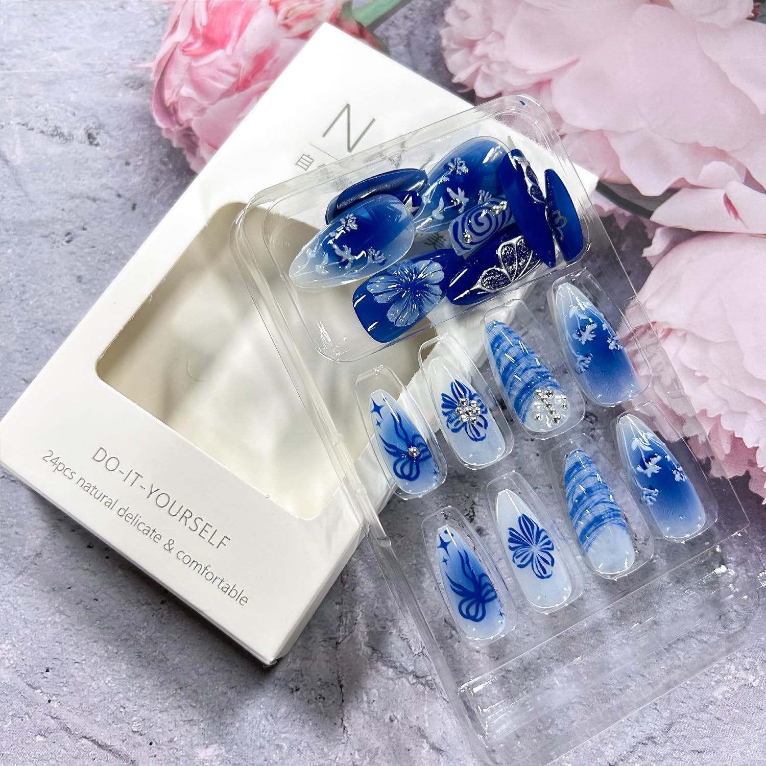 Hand wearing Zrethfb floral butterfly press on nails in medium almond shape