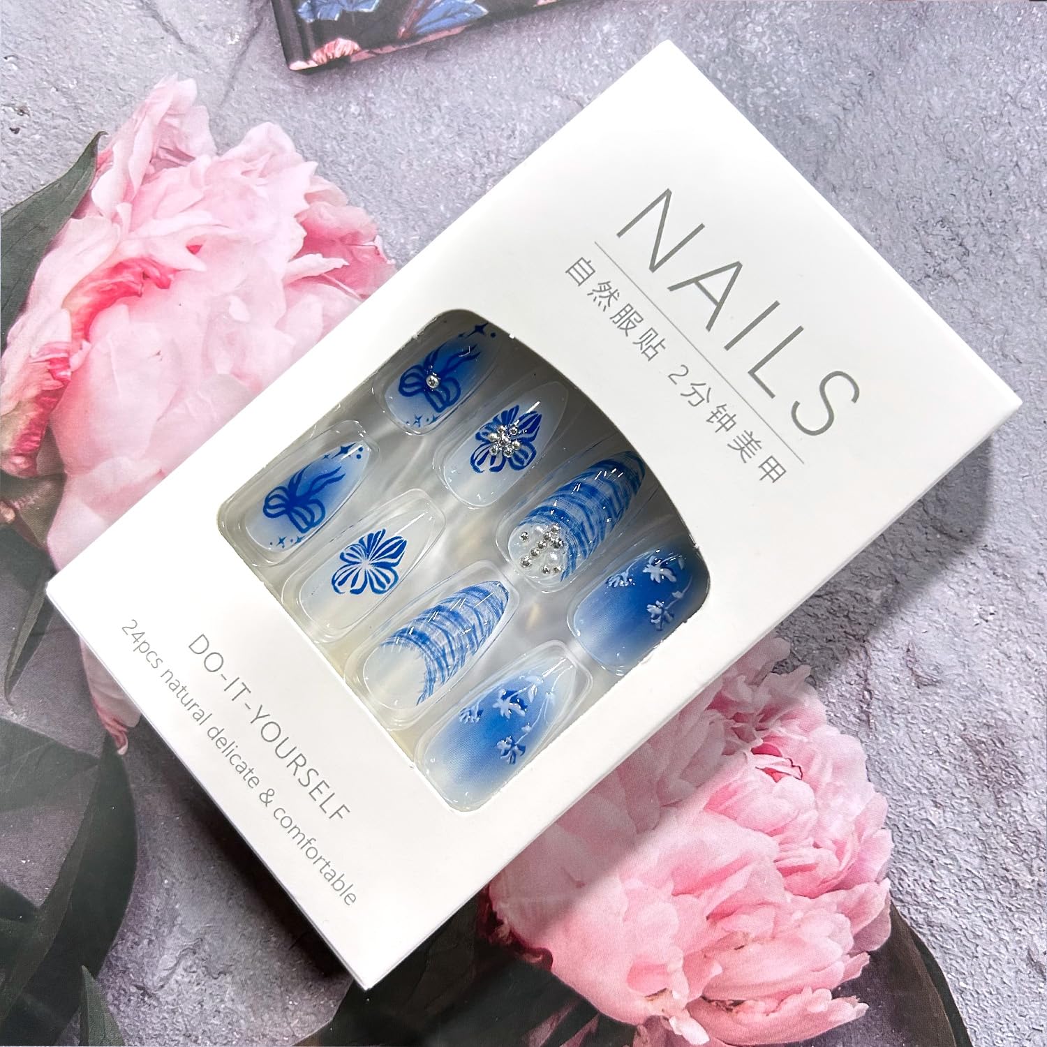 Angle view of blue floral butterfly and pearl press on nail kit