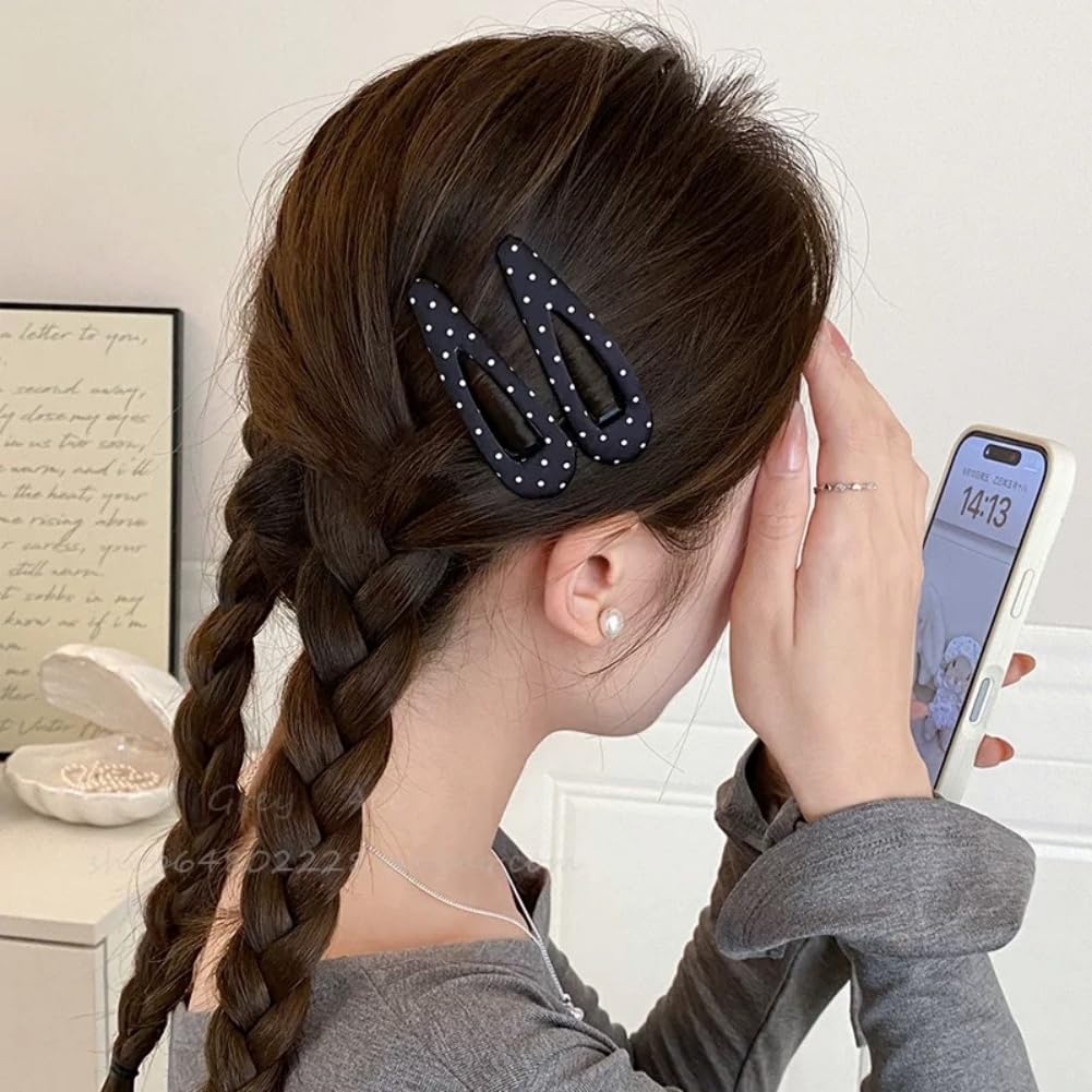 Close up view of the small styling hair pins demonstrating the secure metal snap mechanism.
