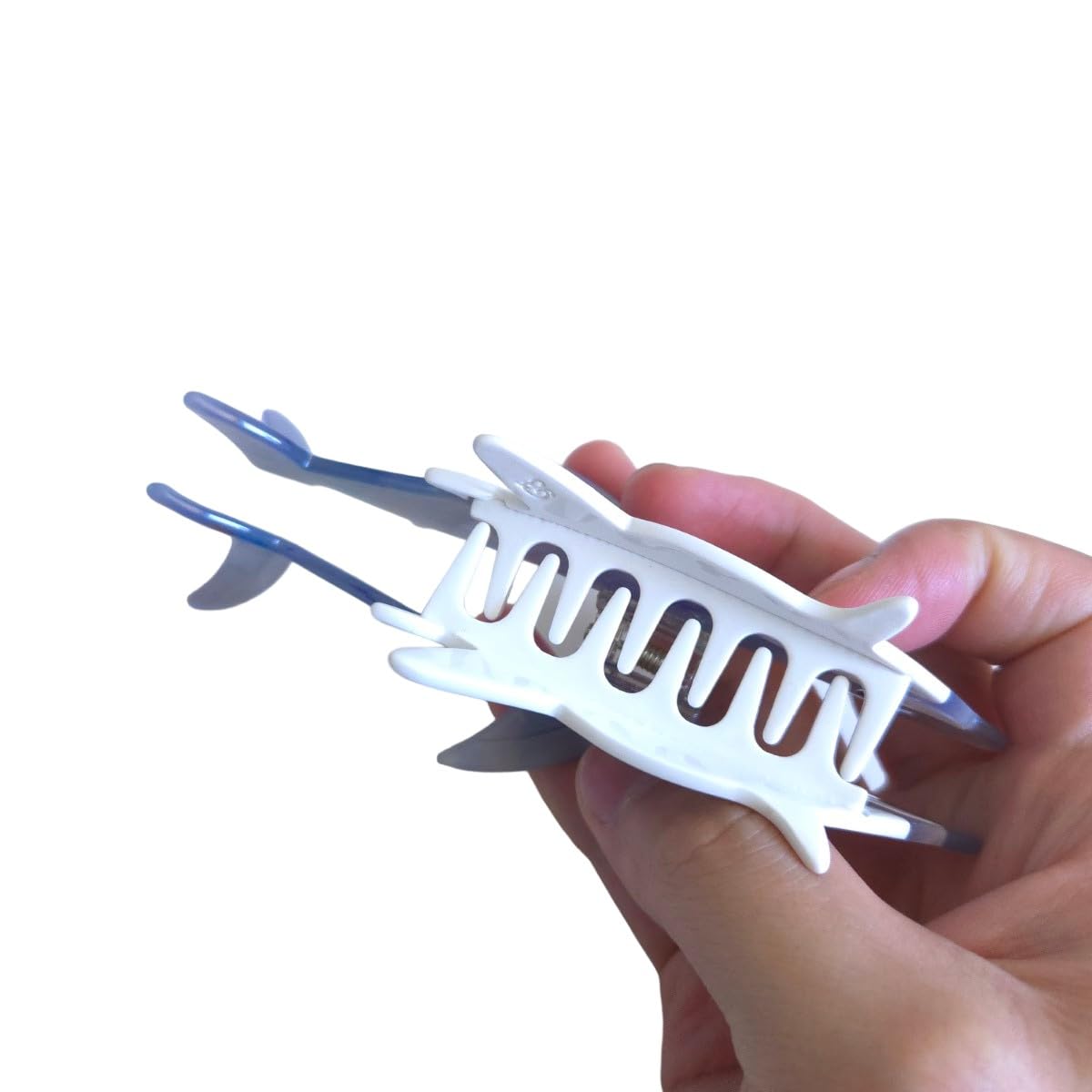Close up of the retro color stitching pattern on the durable OMG Decor shark hair clip showing its premium texture.