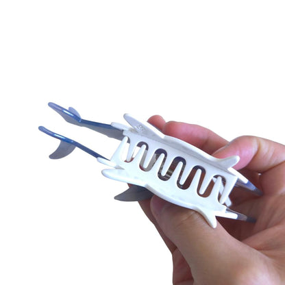 Close up of the retro color stitching pattern on the durable OMG Decor shark hair clip showing its premium texture.