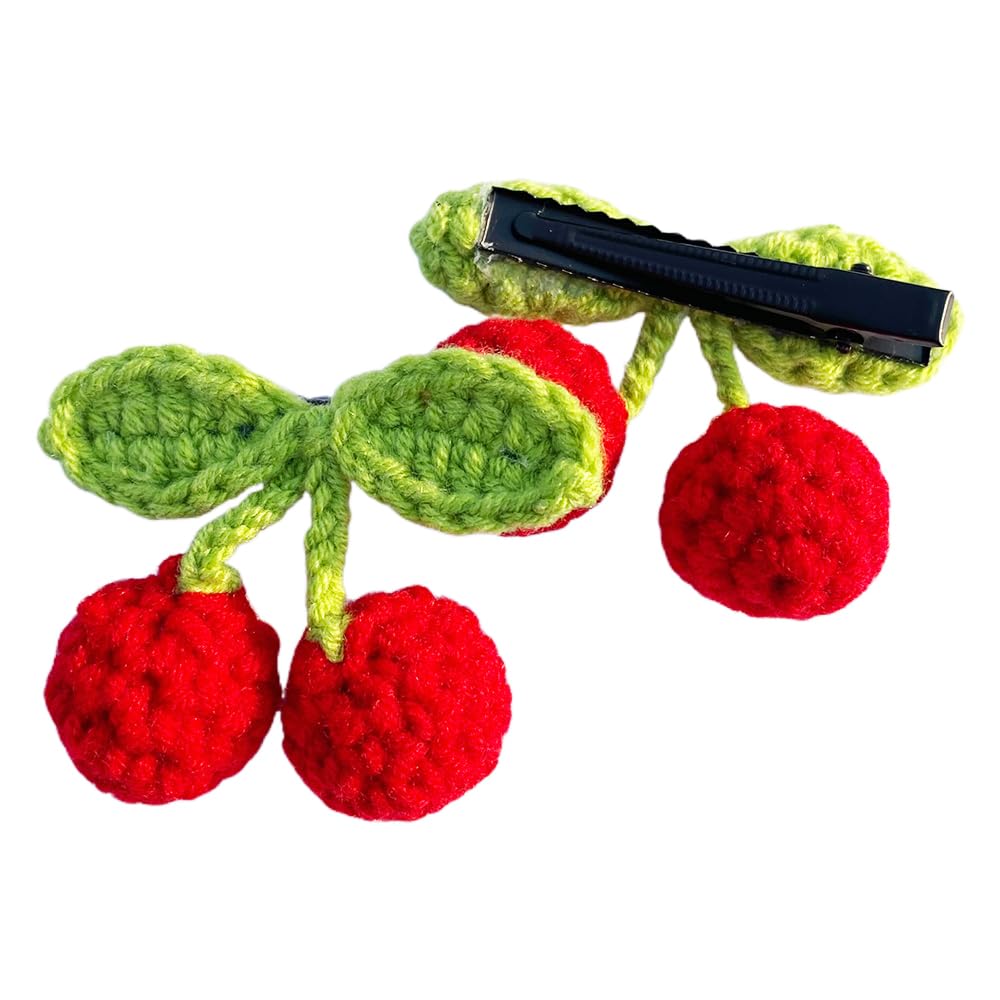 Artisan crafted red cherry and green leaf hair accessories demonstrating secure hold capability