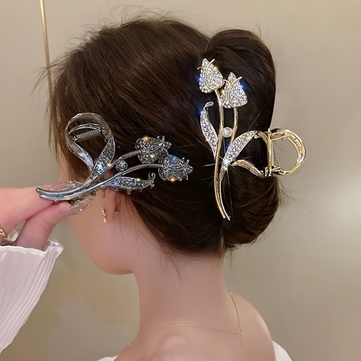 Close up view of the shimmering faux rhinestones on the silver tone floral jaw clip