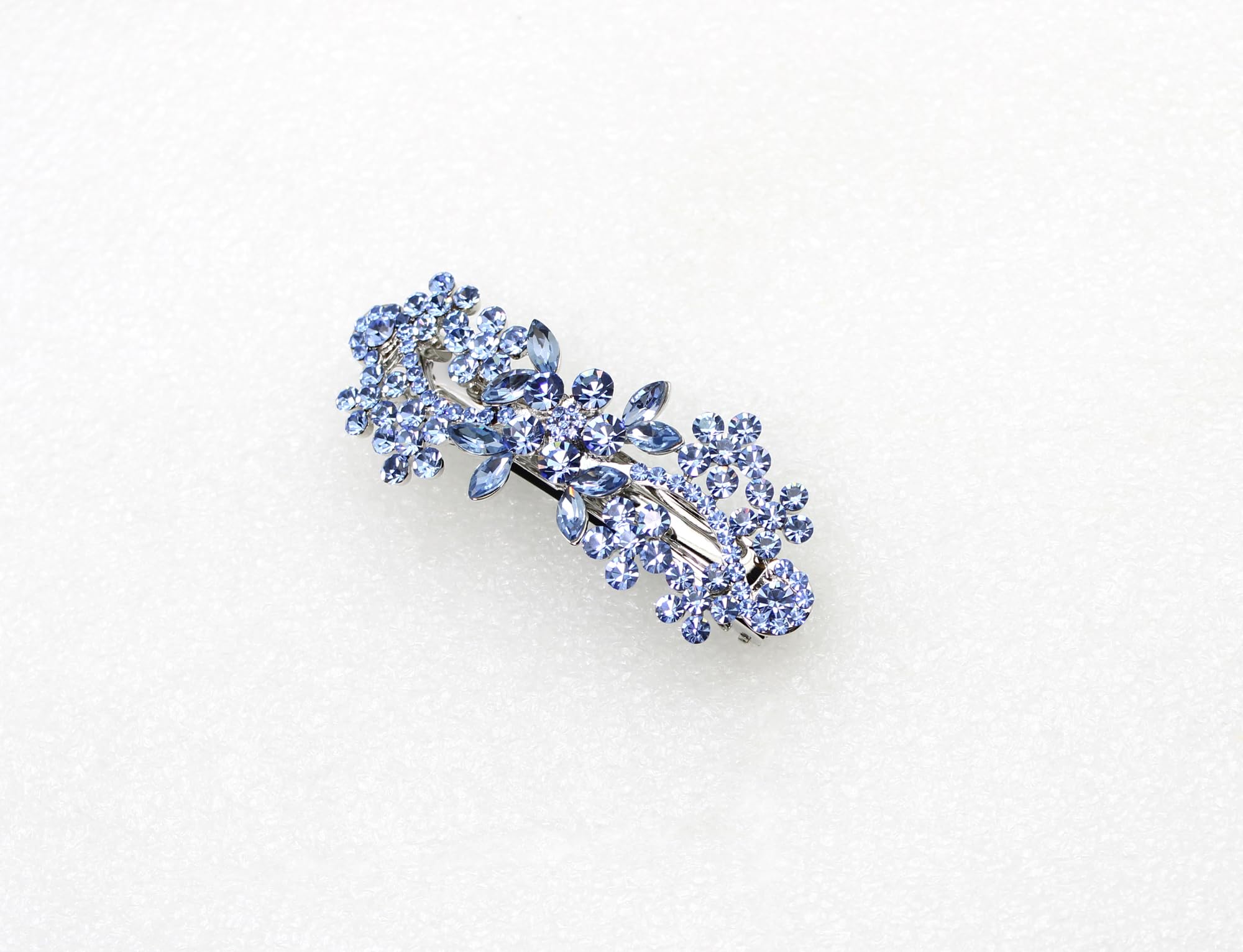 Detailed close up of intricate blue flower design with crystal glass accents for party styling