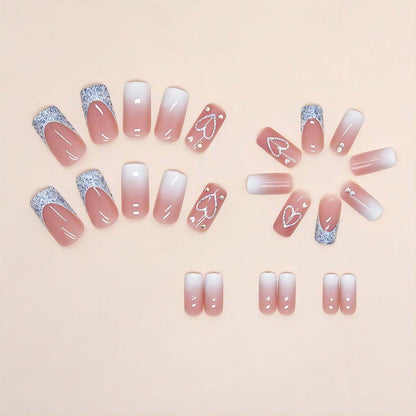 Close up of pink ombre square press on nails with heart detail