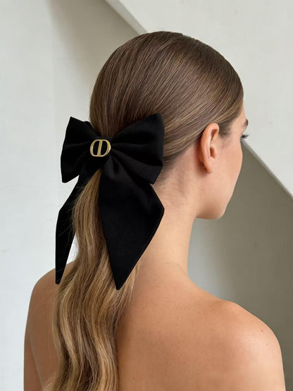 Side profile of the premium structured twist bow accessory worn in a low ponytail