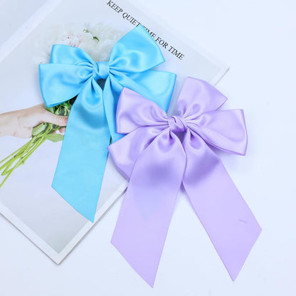 Full retail packaging presentation of the eight pieces set of imported large silky ribbon hair clips.