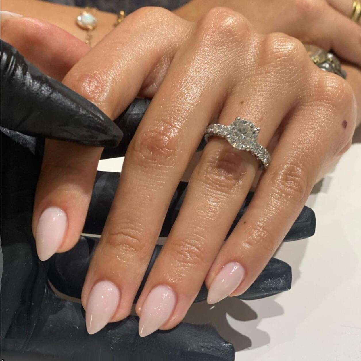Close up of glossy dusty pink acrylic fake nails