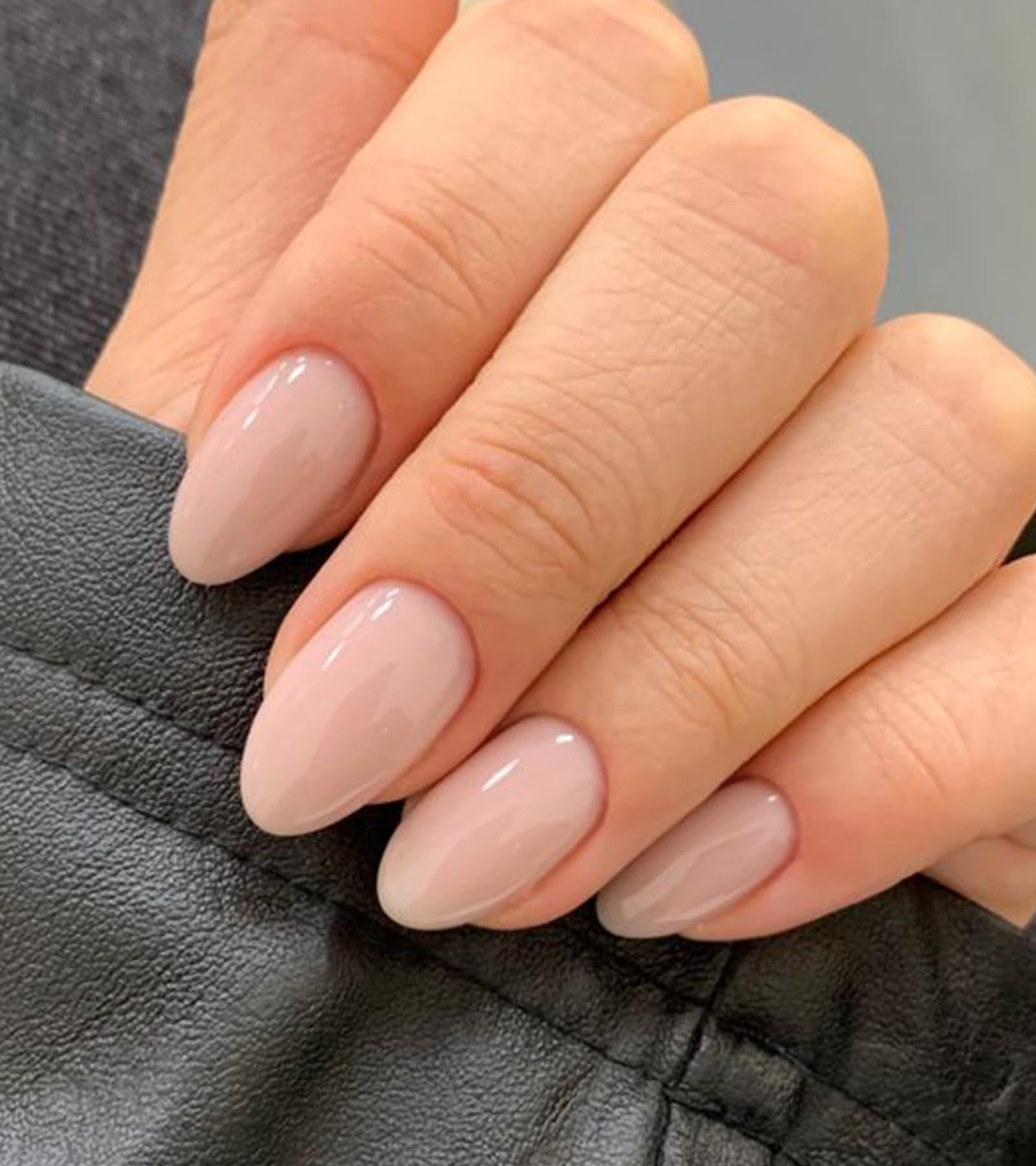 Close up of Artquee glossy almond nails on hand