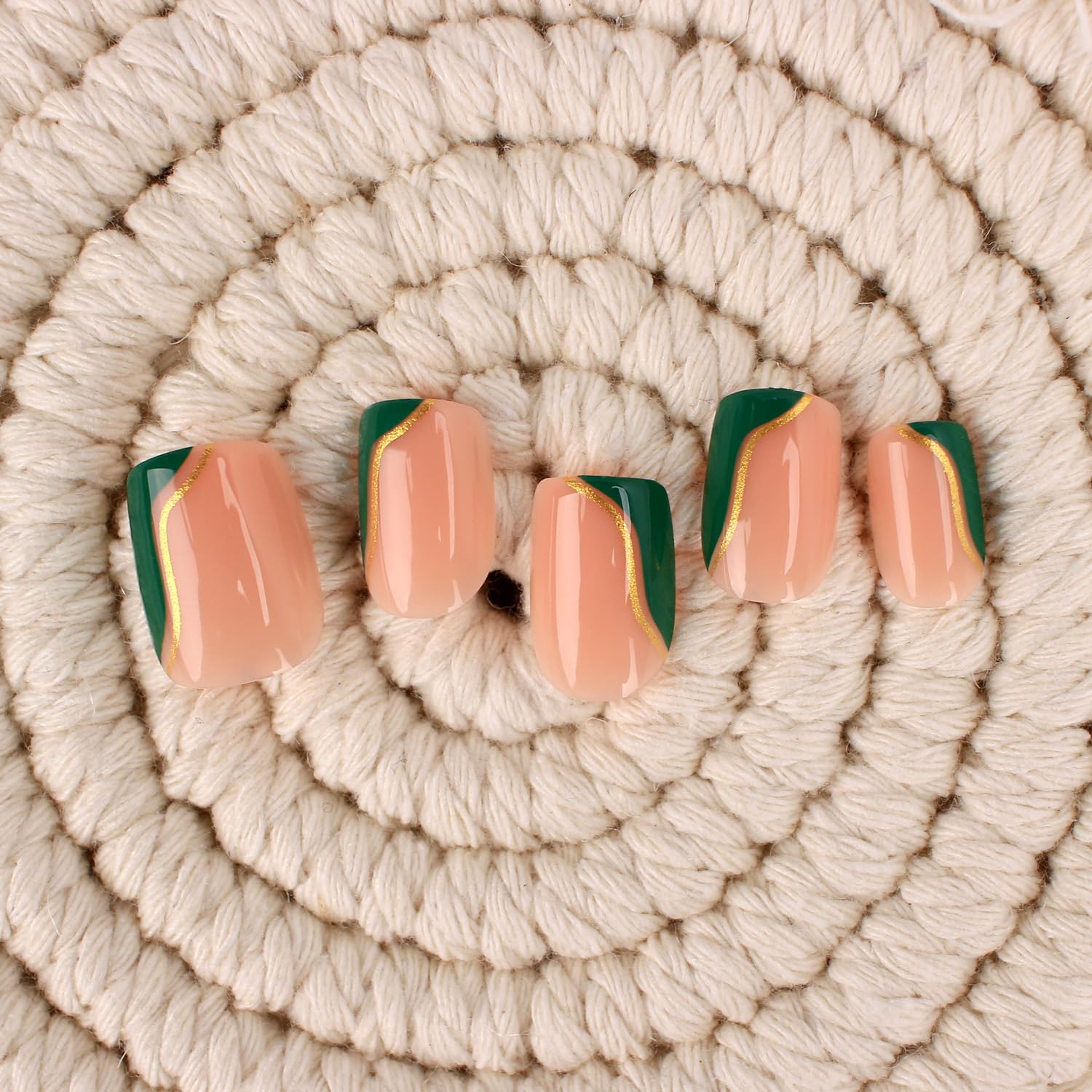 Close up of Mivota fall press on nails with gold stripe detail