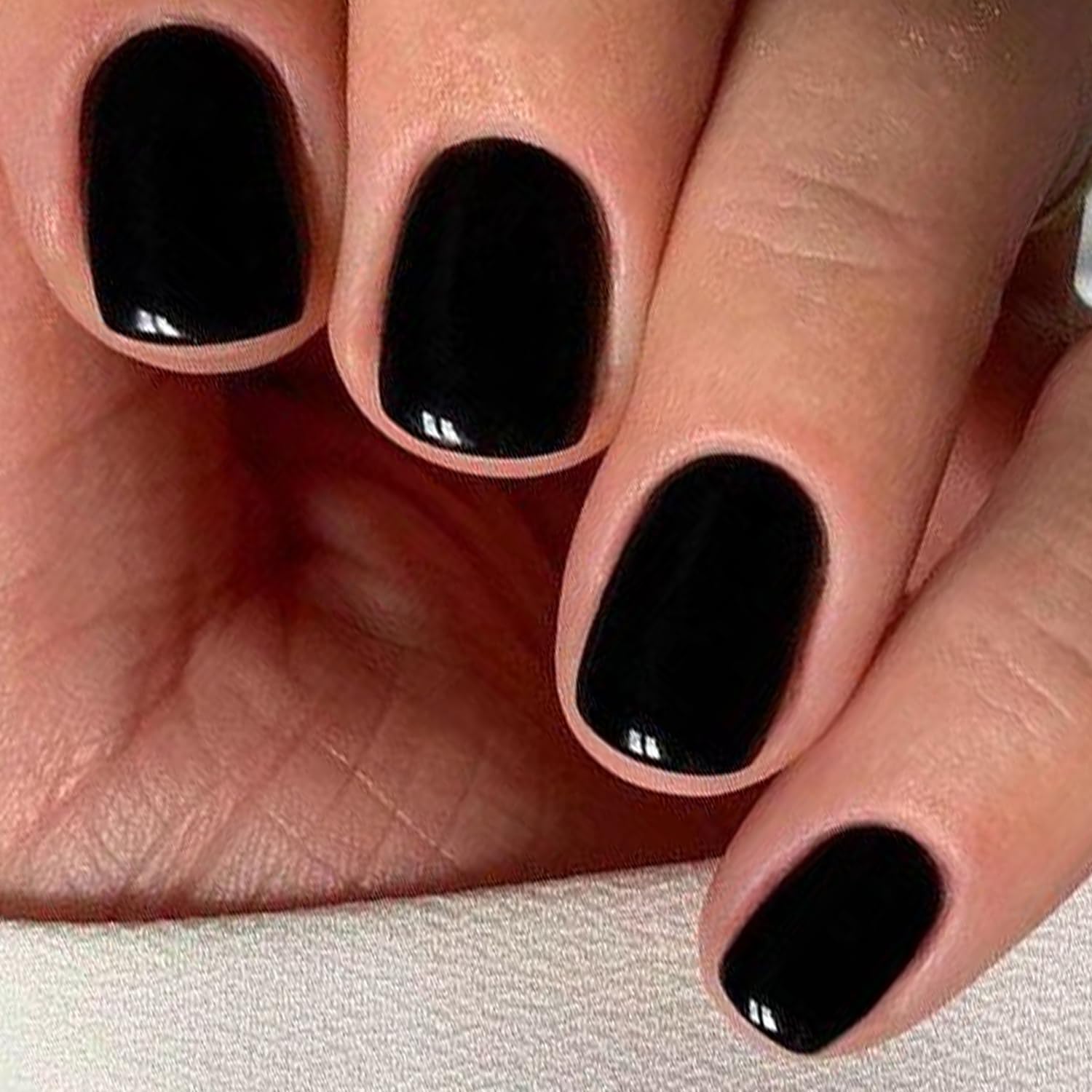 Close up of Glamermaid black squoval press on nails glossy finish