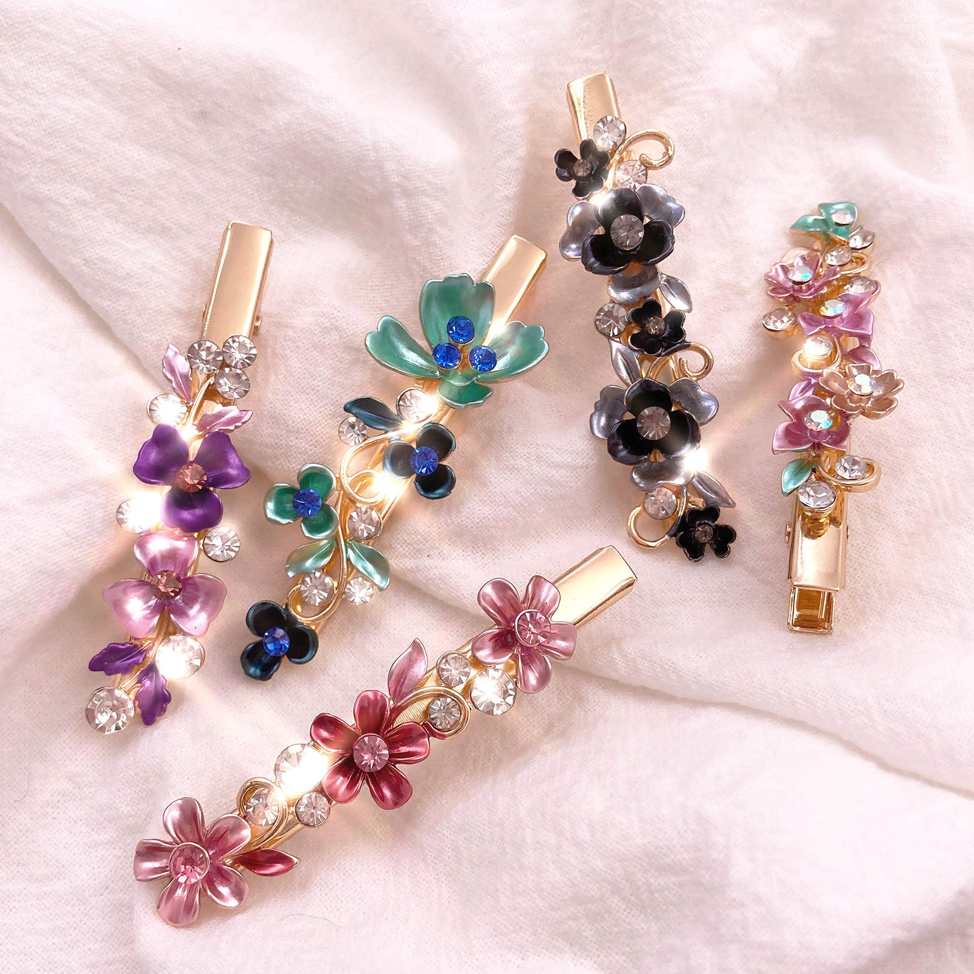 Lizzie Kay butterfly and leaf patterned metal hair clips illustrating the spring mechanism and lightweight build