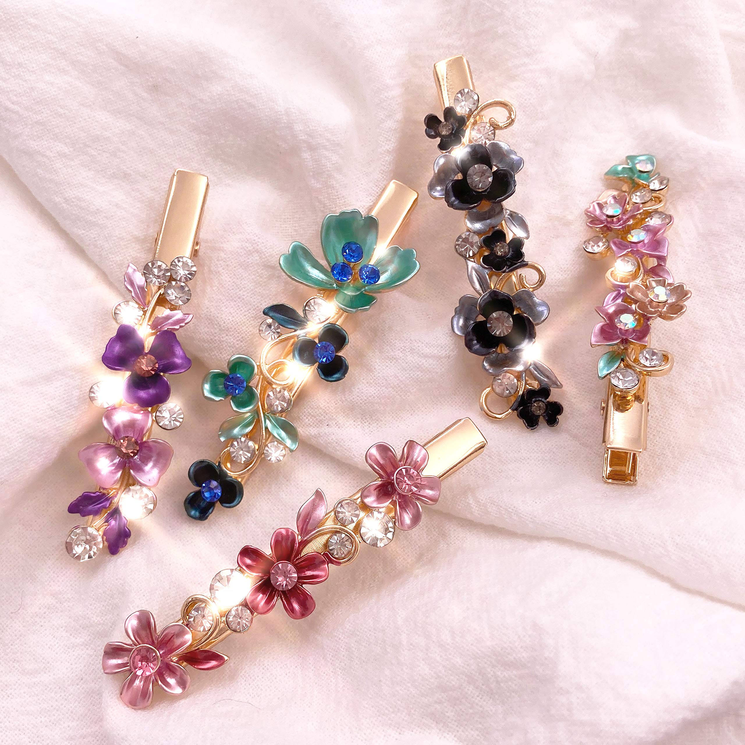 Lizzie Kay butterfly and leaf patterned metal hair clips illustrating the spring mechanism and lightweight build