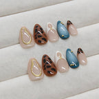 Model wearing medium almond shaped leopard French tip press on nails