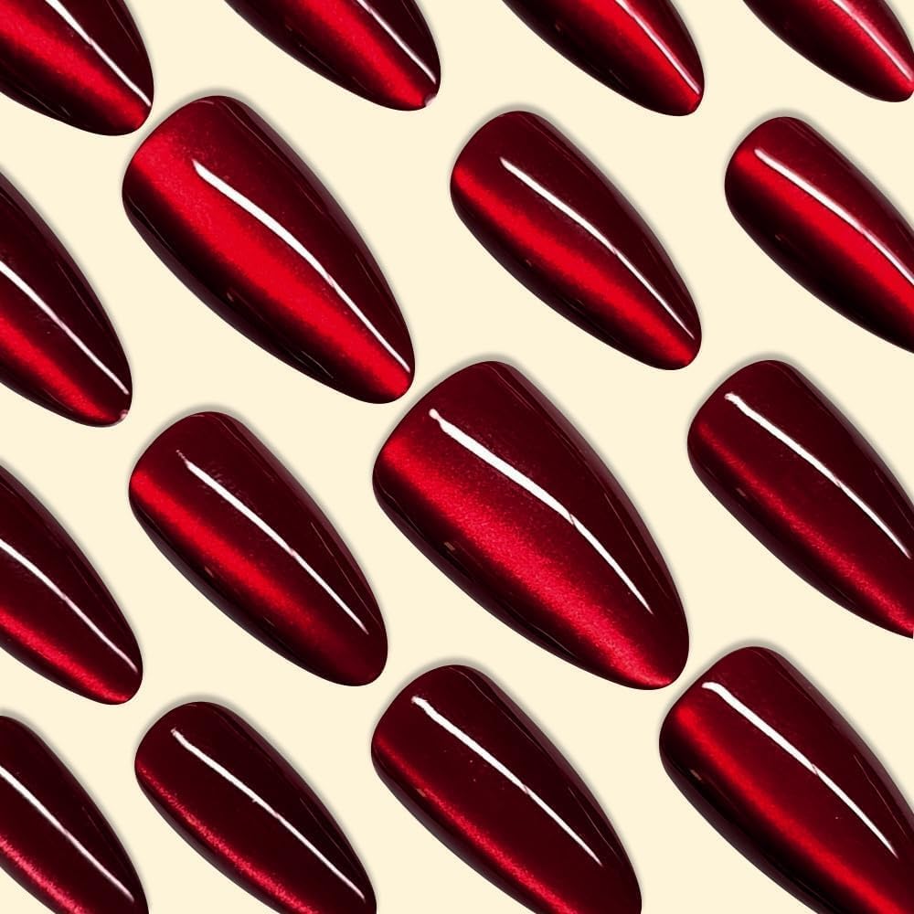 Close up of ruby red cat eye effect on almond fake nails