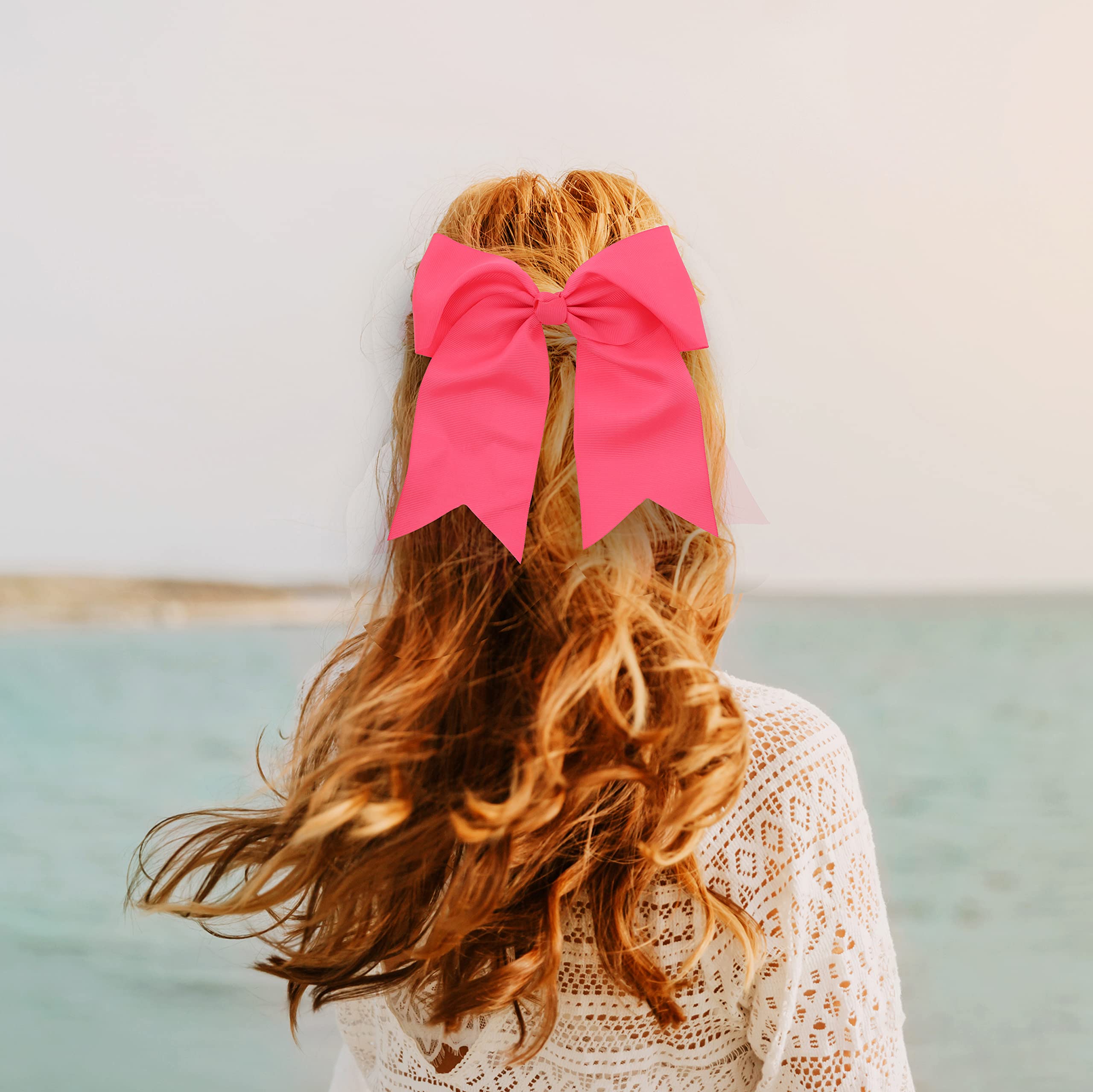 Oversized neon pink hair bow with long tails by Motique Accessories showcasing the three inch metal alligator clip.