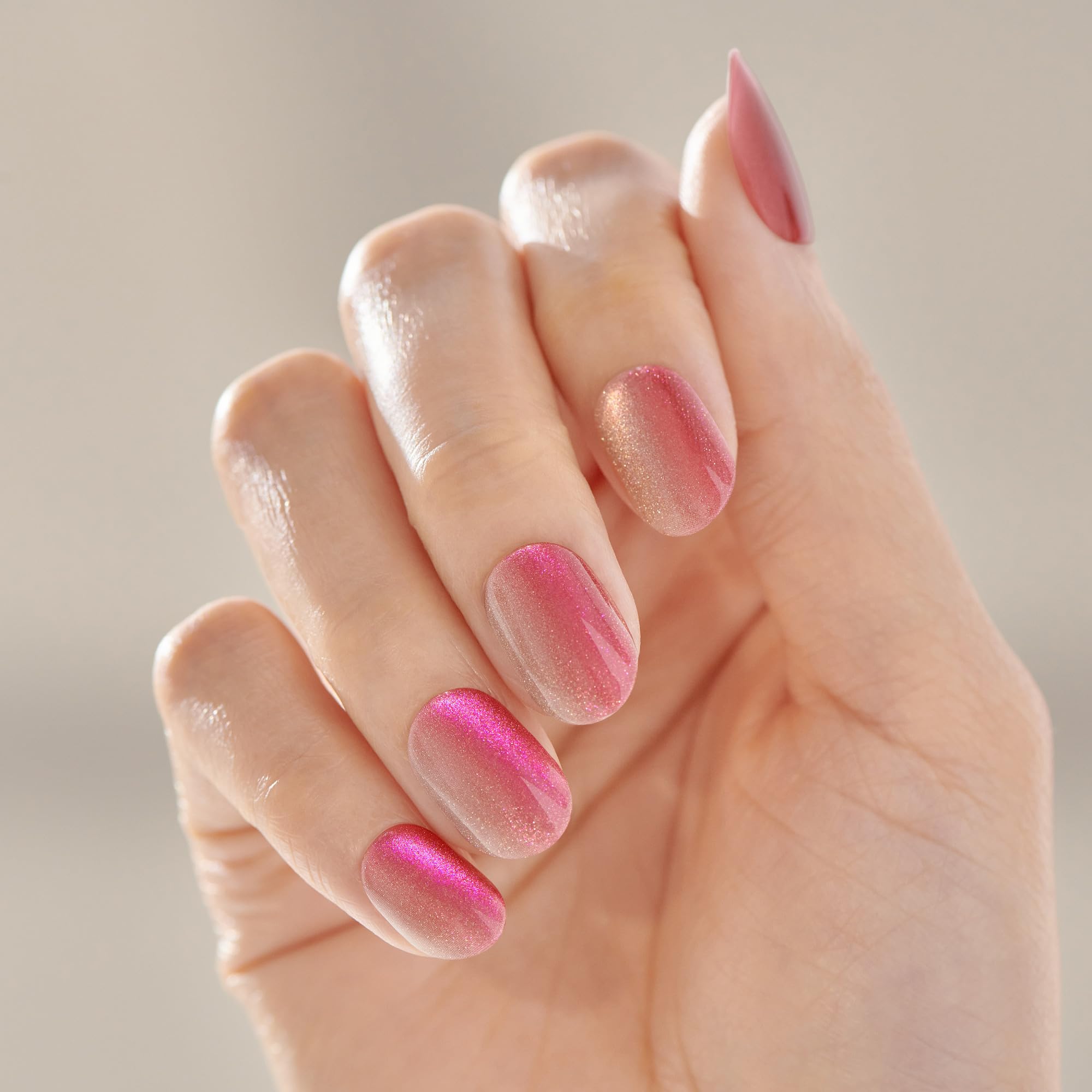 Close up of vibrant pink chrome finish on Kiss Impress short oval nails