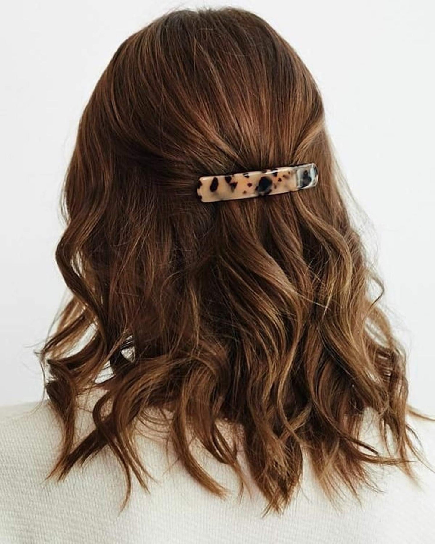 Close-up view of the smooth celluloid acetate texture on the Eyegla rectangle hair clips highlighting the unique luxury pattern.