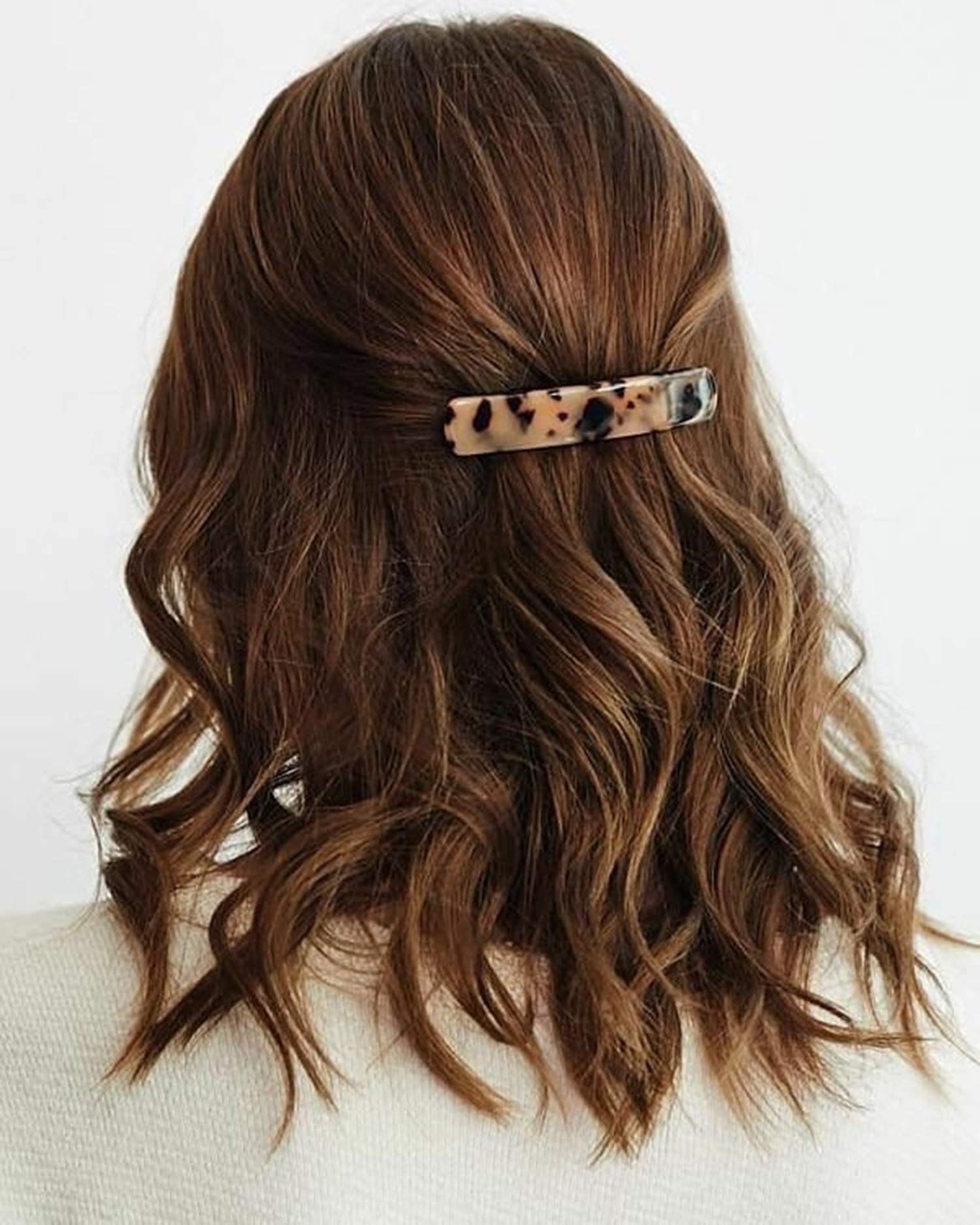 Close-up view of the smooth celluloid acetate texture on the Eyegla rectangle hair clips highlighting the unique luxury pattern.