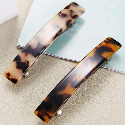 Back view of the Eyegla tortoise shell hair barrette demonstrating the sturdy metal automatic spring closure mechanism.