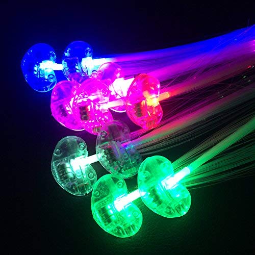 Side view profile of a girl wearing glowing fiber optic hairpins in a dark party room
