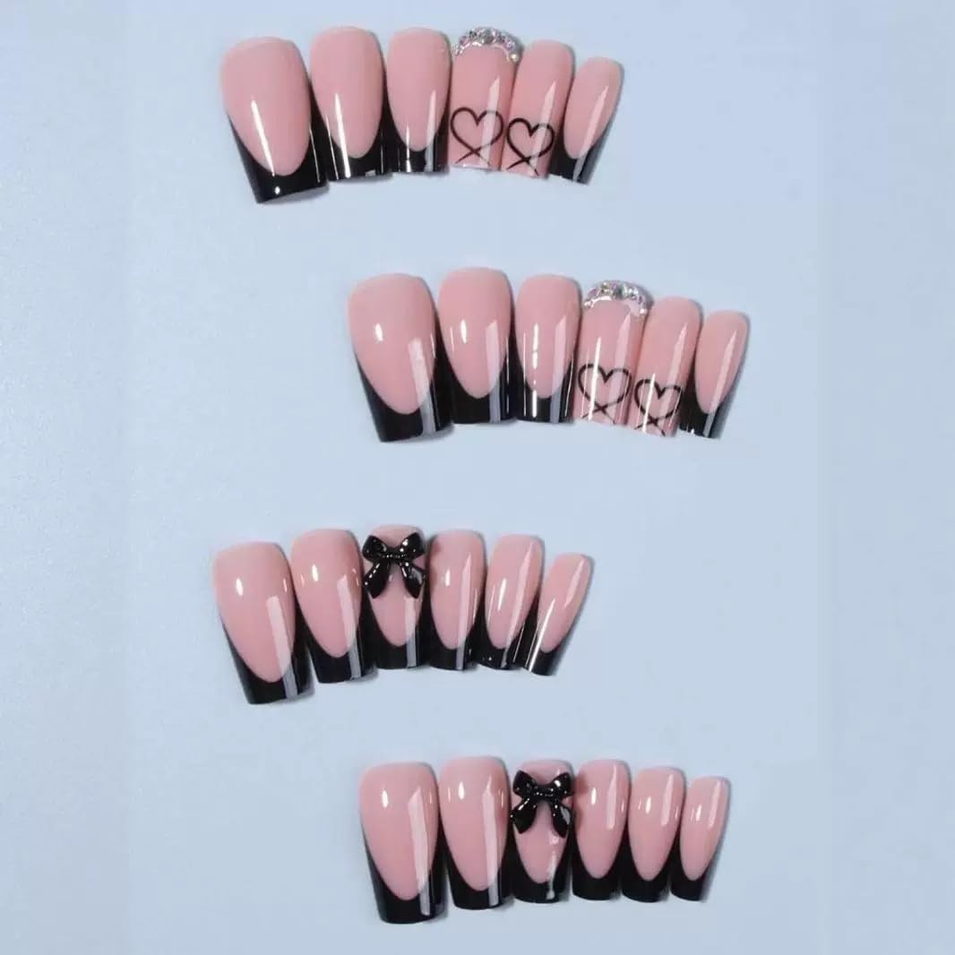 Close up of black french tip coffin nails with 3D bows