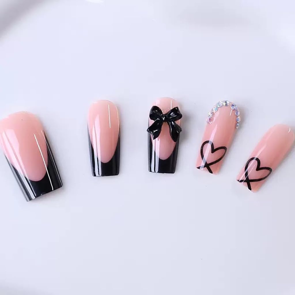 Detailed view of resin bow charm on black french nail