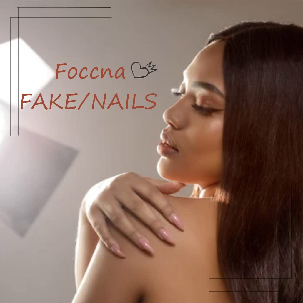 Flat lay view of Tarini Foccna almond shaped fake nails with gold studs