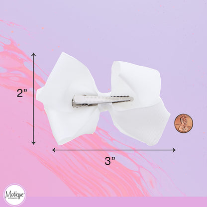 Motique Accessories imported white hair bows for kids displaying the knotted center and premium ribbon texture