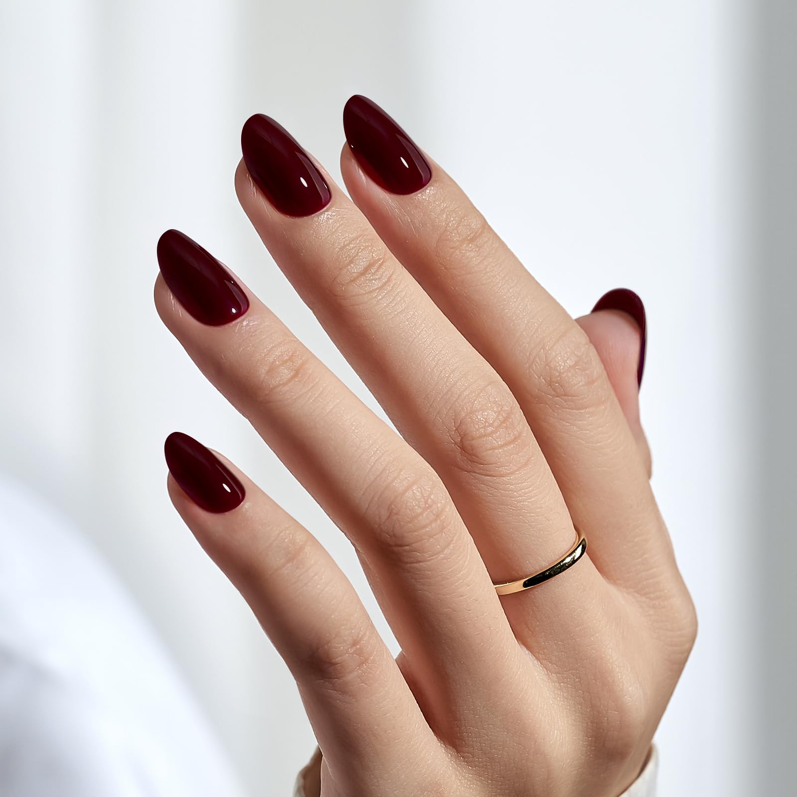 Close up of deep burgundy glossy press on nails
