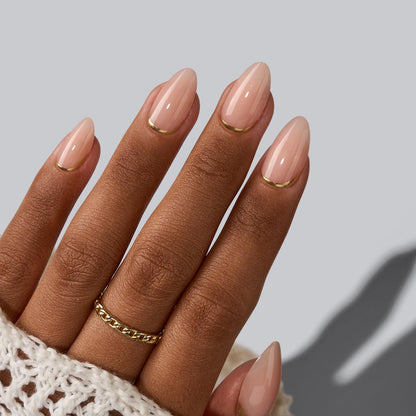 Close up of gold foil almond shaped press on nails