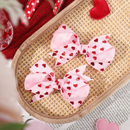 Side view of red and pink heart hair barrettes