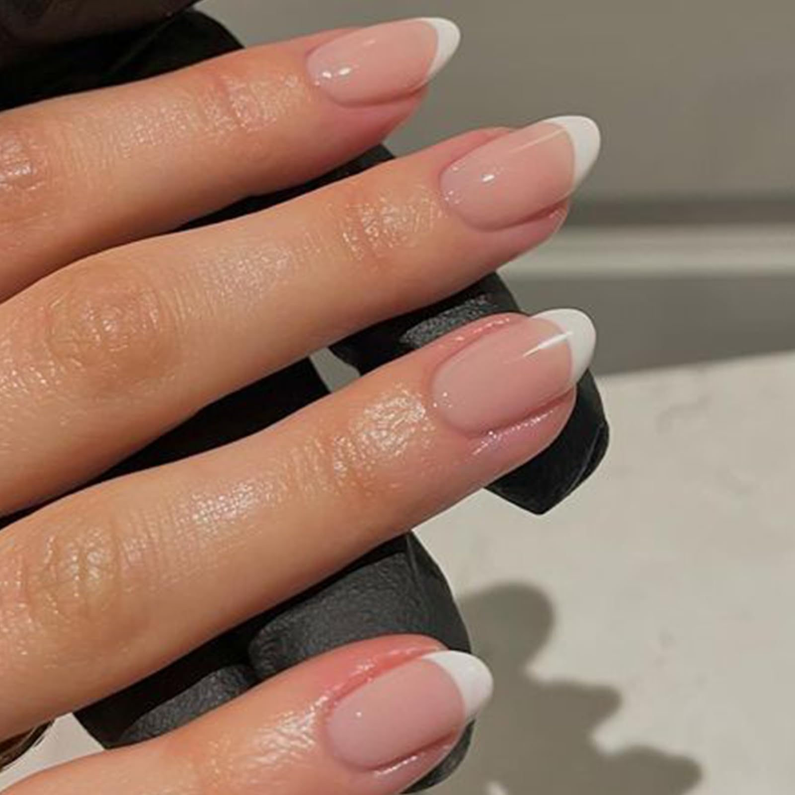 Modelones French Tip Press On Nails on fingers showing short oval shape