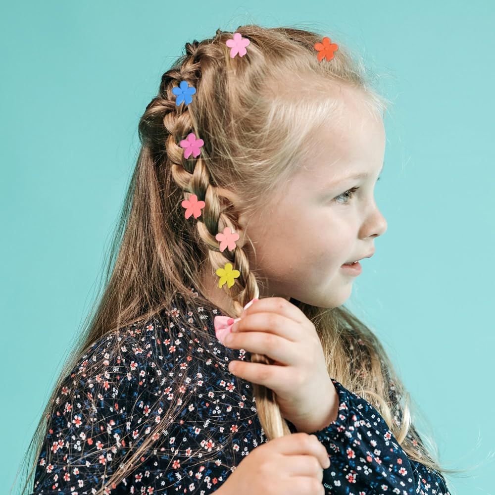Assorted pastel and vibrant matte colors of the mini flower hairpins scattered on a clean surface.