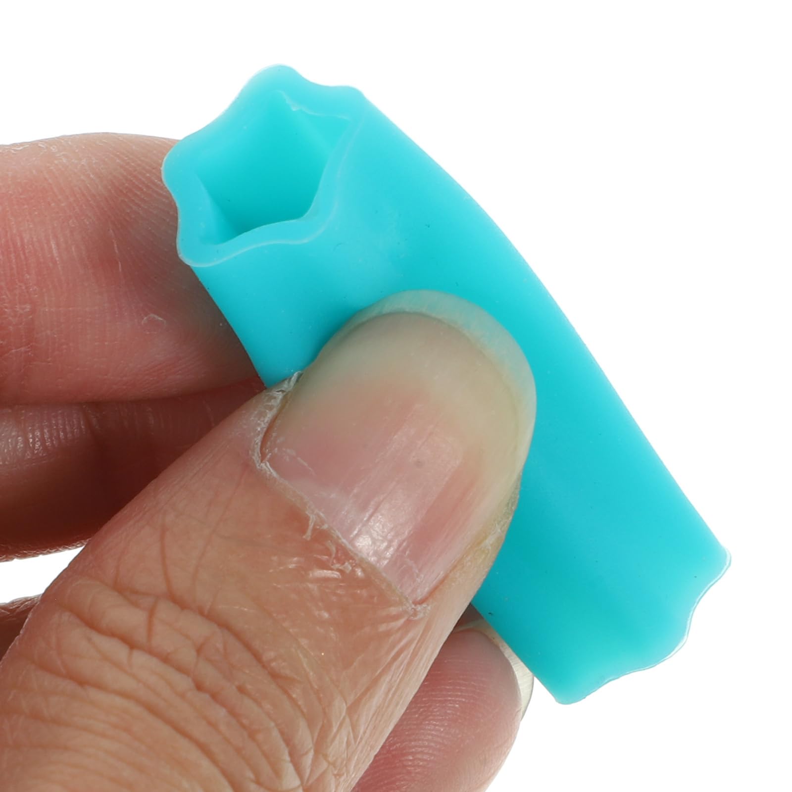 Flexible silicone protective cuticle nipper cover stretched over grooming tweezers to demonstrate material elasticity.