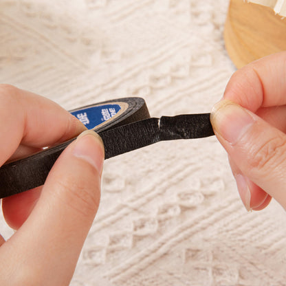 Top view of Bouttarro black fingerless gloves and adhesive cuticle tape