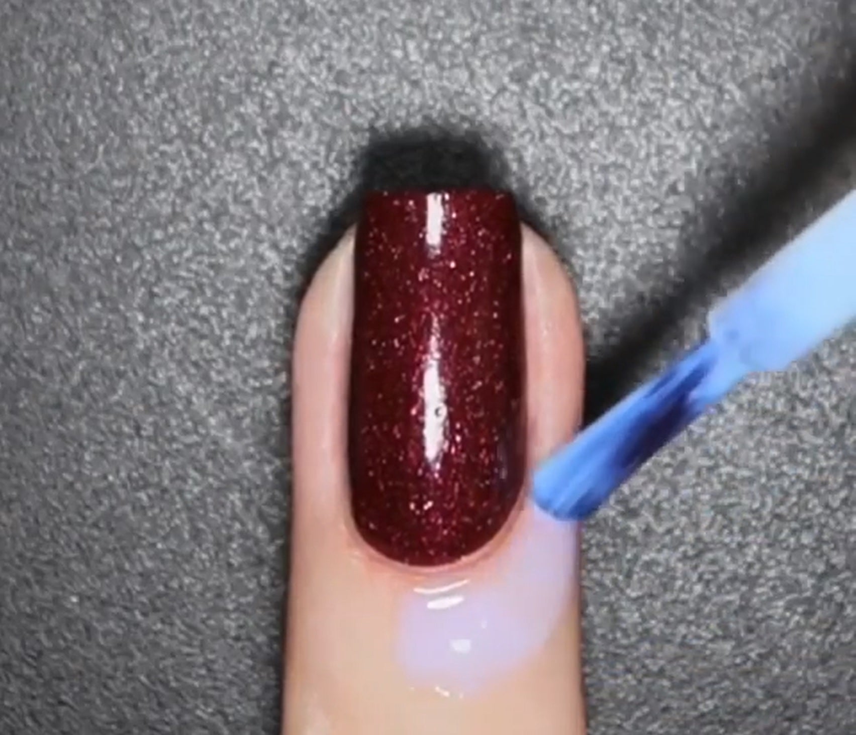 Peeling off the PUEEN latex free nail barrier after completing clean nail art