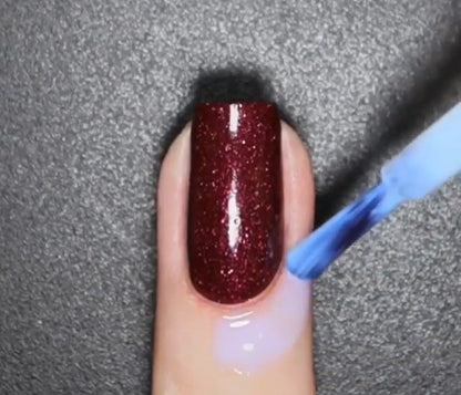 Peeling off the PUEEN latex free nail barrier after completing clean nail art