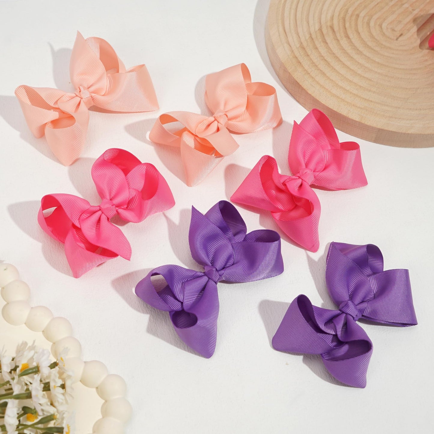 Assorted vibrant color pairs of CÃ©llot boutique hair bows for toddlers