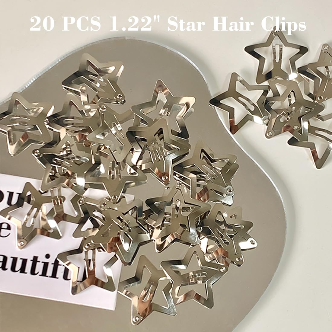 Close up view of the 1.22 inch silver metal snap mechanism on the star hair clip.