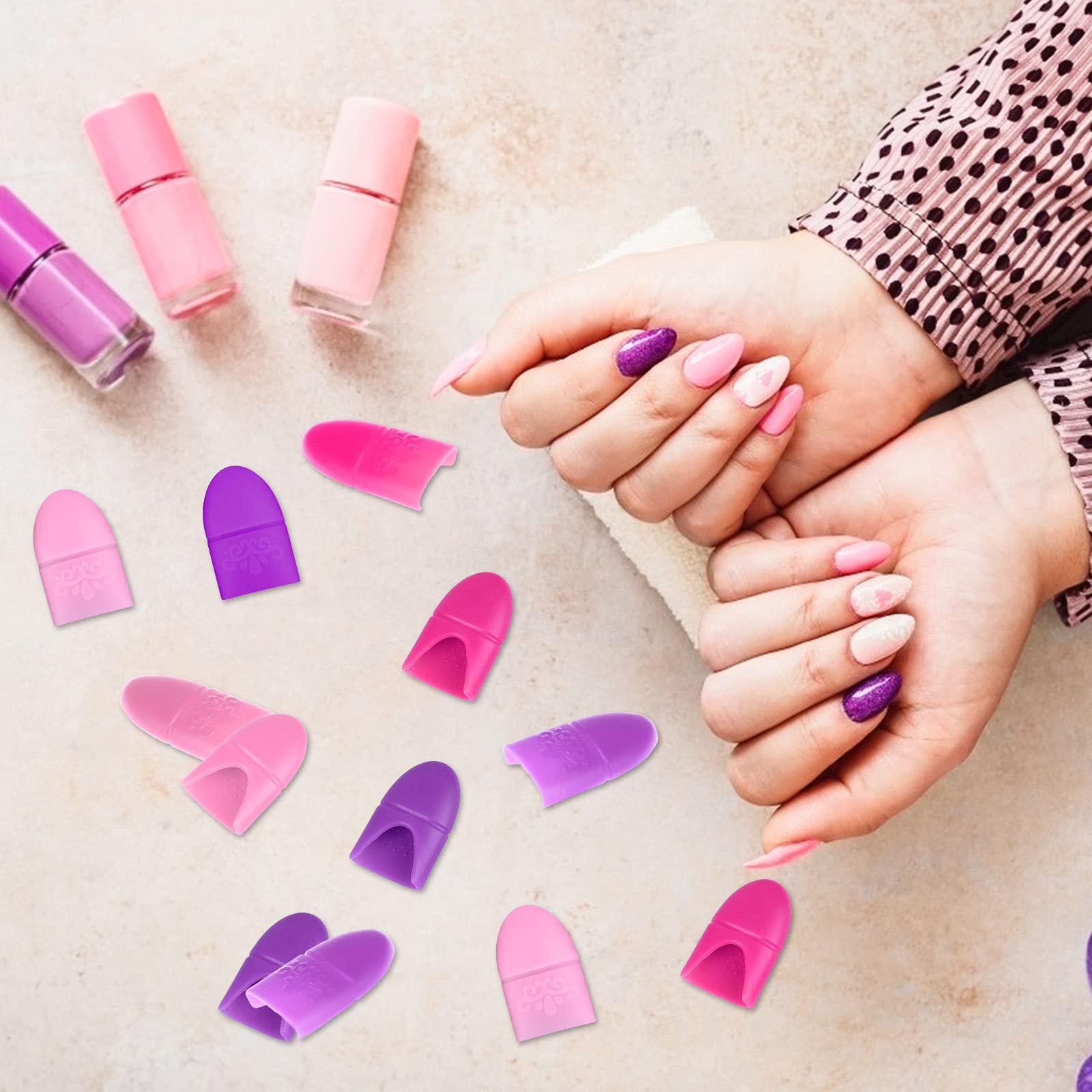 Hand wearing pink and purple silicone nail polish finger protectors