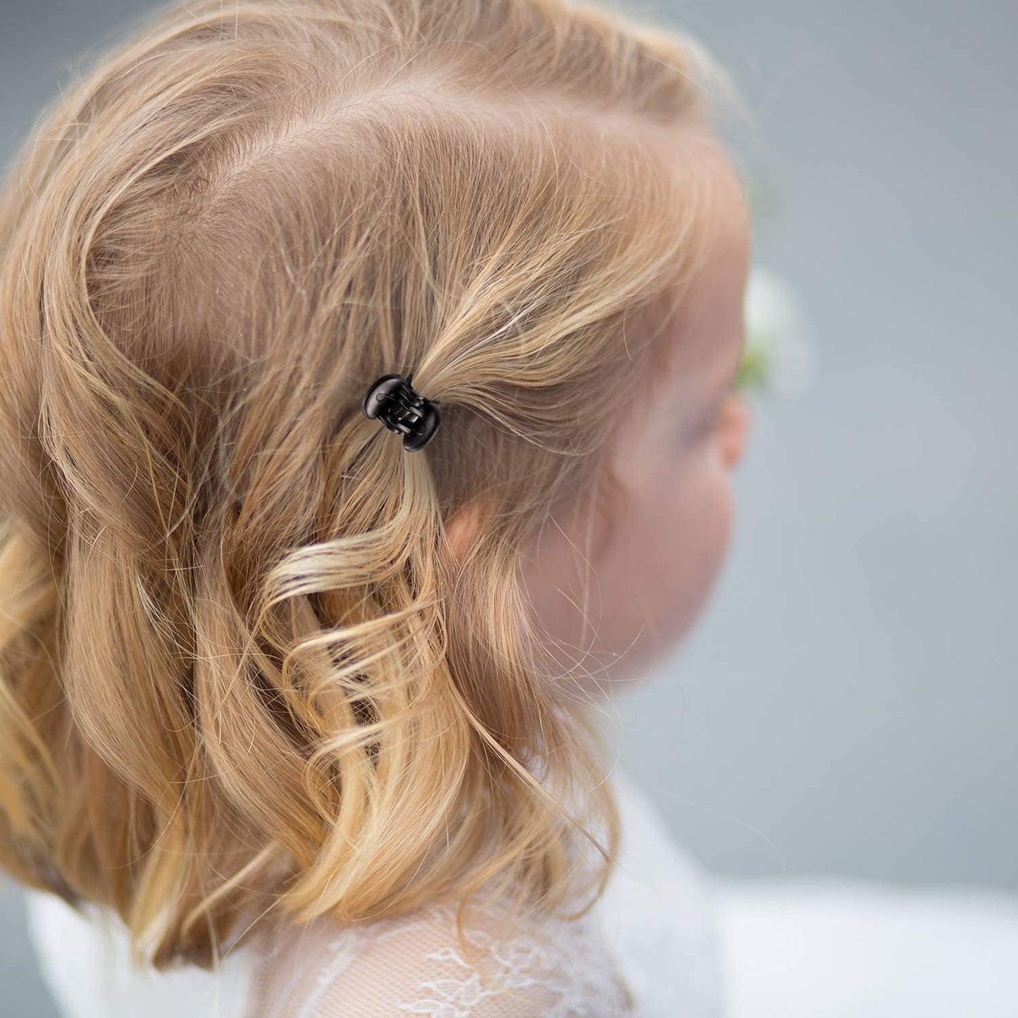 Thirty six piece pack of small plastic hair clips showing three distinct color assortments