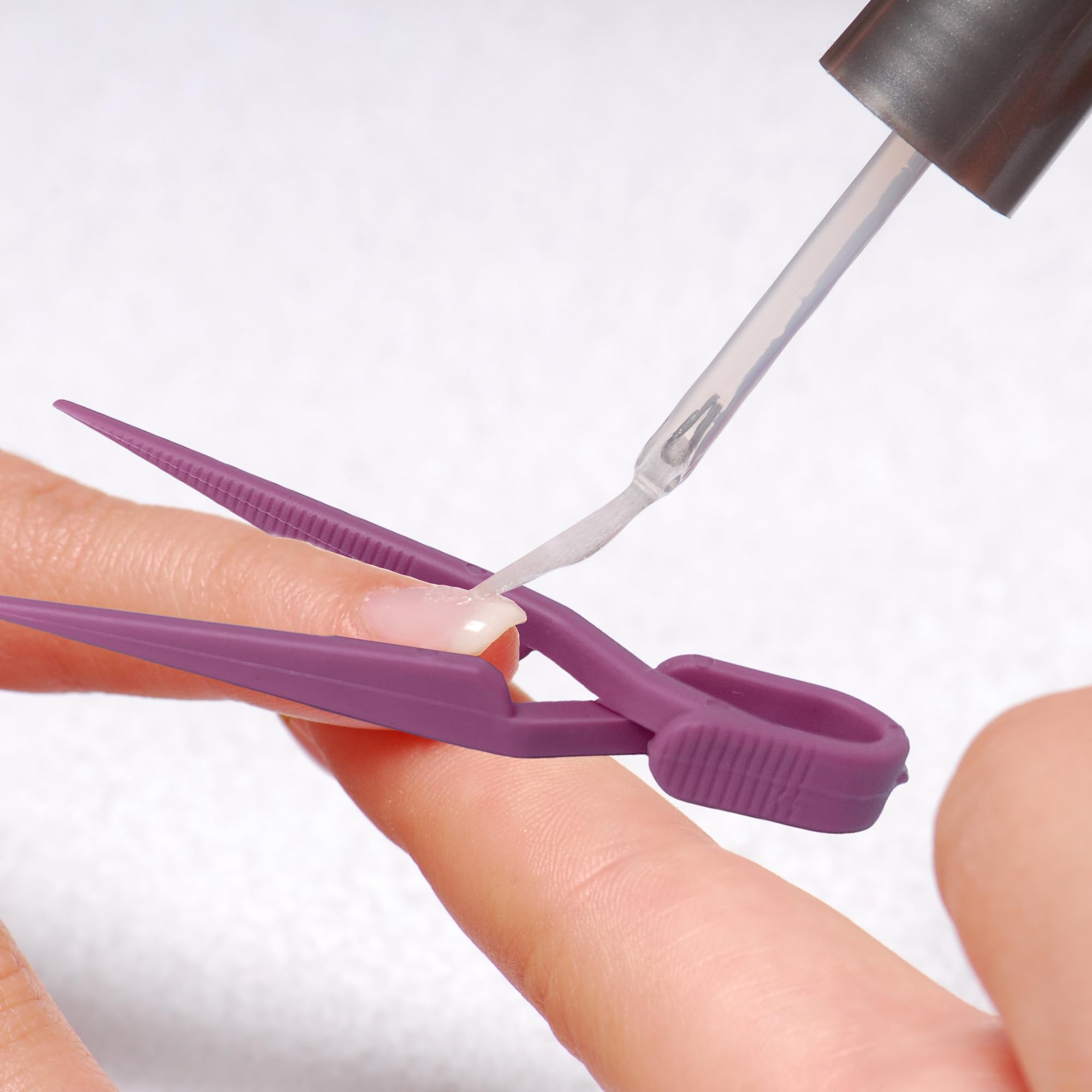 Pink and lavender plastic manicure finger tips cover shield for mess free nail stamping.
