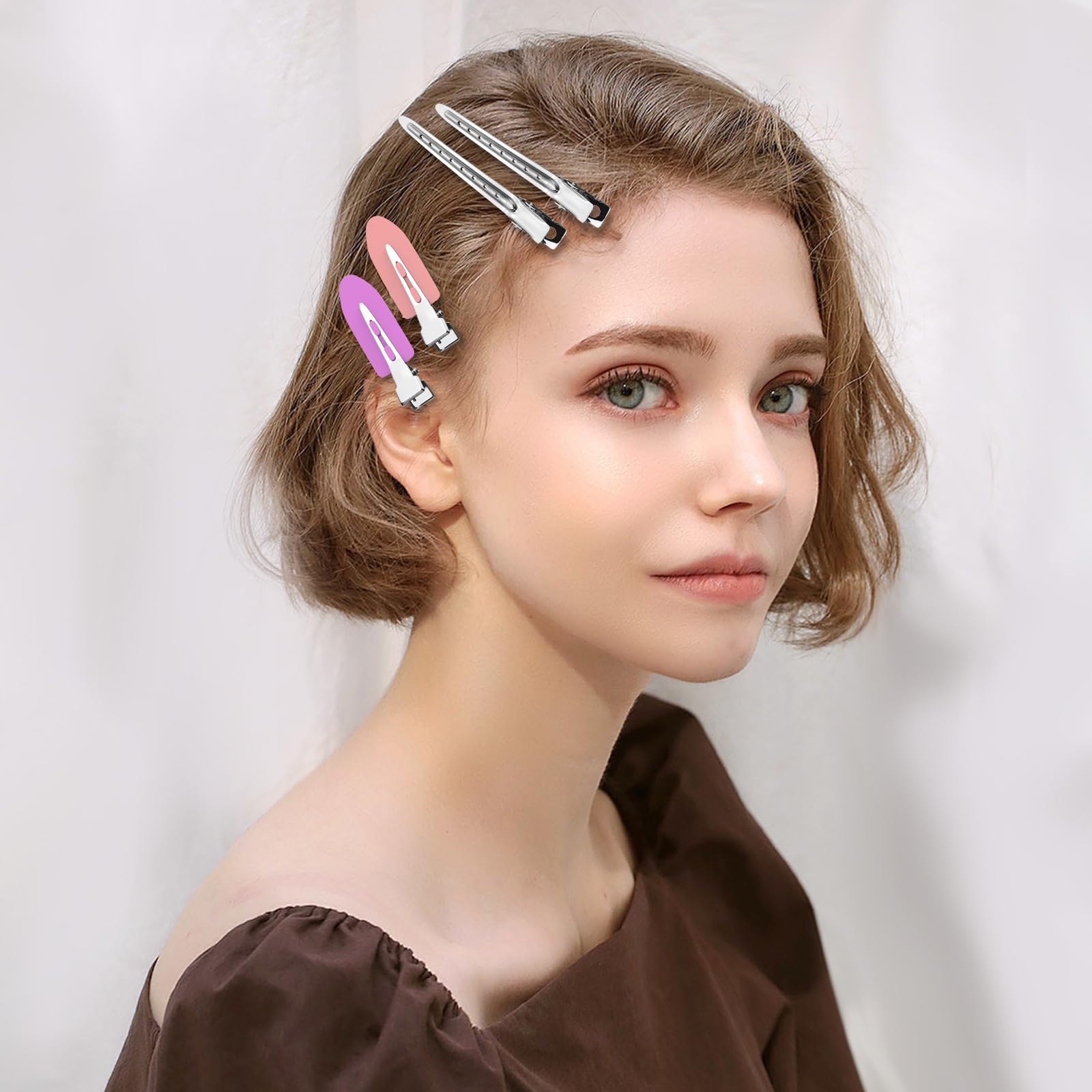 Close up view of the heavy duty nickel plated salon sectioning clips with built in holes.